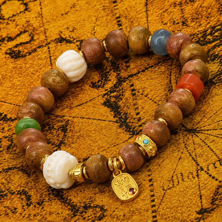 Himalayan Bodhi Wood Mala Bead Bracelet with Carved Melon Beads, Red Agate, Green Jade, and Gold-Tone Mantra Charm