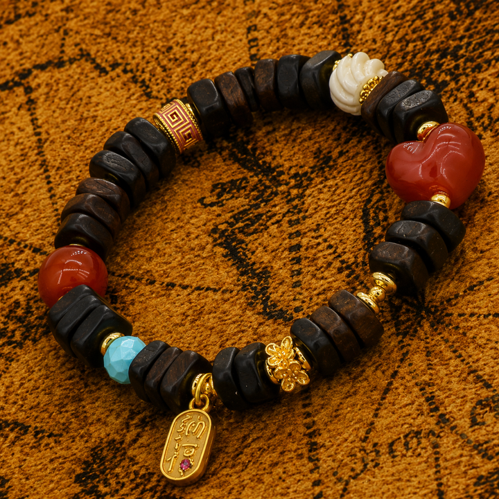 Handmade Himalayan Dark Wood Flat Bead Bracelet Featuring Red Agate Heart, Turquoise, Carved White Shell, and Gold-Plated Charms