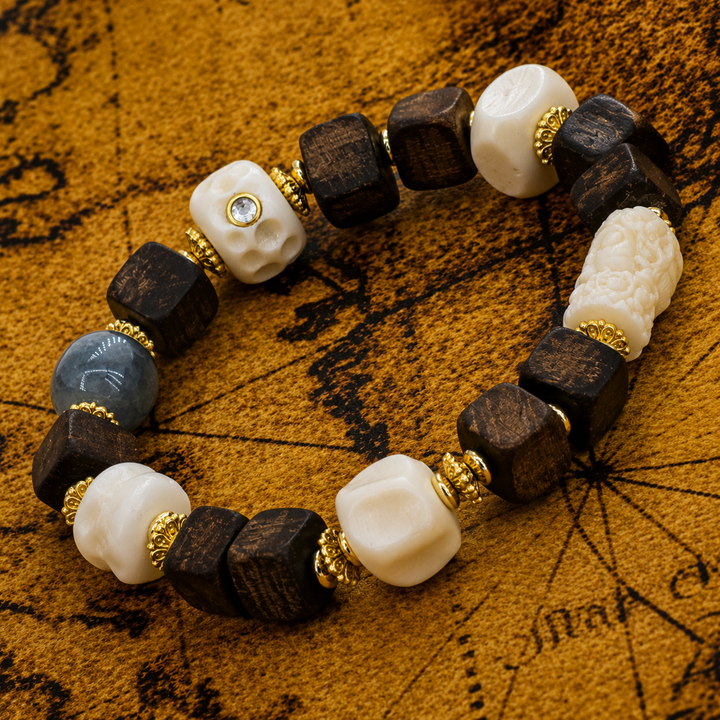 Himalayan Handcrafted Square Dark Wood Bead Bracelet Featuring Carved Bone Skulls, Barrel Motif, Blue Agate, and Gold Accents