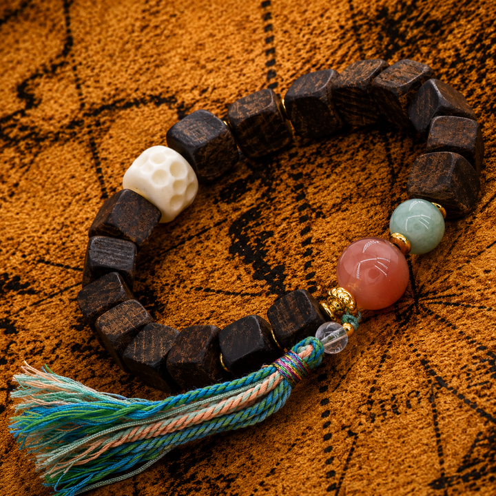 Handcrafted Square Dark Wood Beaded Bracelet Featuring Carved Bone Skull, Pink Agate, Green Jade, Gold Spacers, and Multicolored Tassel